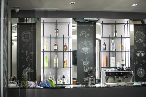 a kitchen with a counter with bottles of alcohol at Admiral Hotel in Elbasan