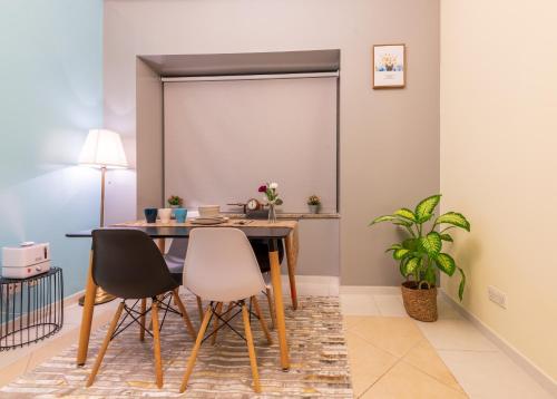 a dining room with a table and chairs at Trinity Holiday Homes - Sheikh Zayed Road Near to Financial Center Metro Station in Dubai