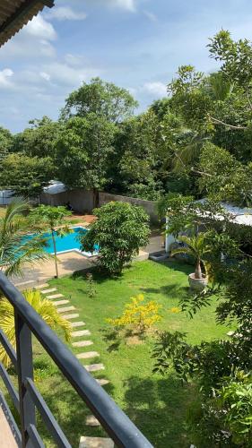 a view of a garden with a swimming pool at Sapphire Garden Hotel in Habarana