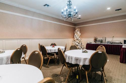 a dining room with tables and a christmas tree at Church Street Inn in Natchitoches