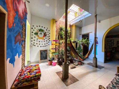 a living room with potted plants and a wall at La Casa de Adry in Cali