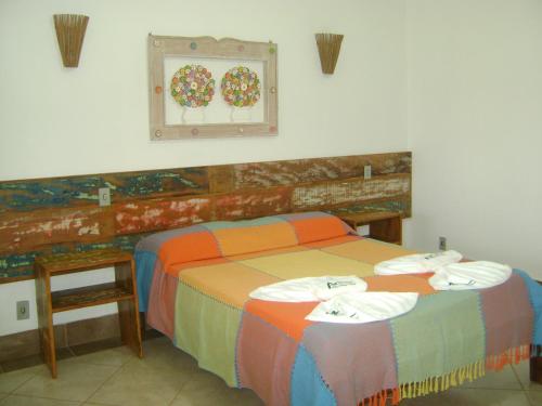 A bed or beds in a room at Pousada Serra Azul