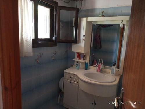 a bathroom with a sink and a mirror at Sea view Dilesi in Dhílesi