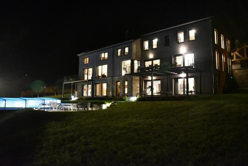 a large building at night with lights on it at Rochehaut, Les Semoiselles, Villa Isabelle in Bouillon