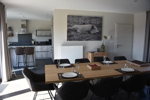 a dining room with a wooden table and chairs at Rochehaut, Les Semoiselles, Villa Isabelle in Bouillon