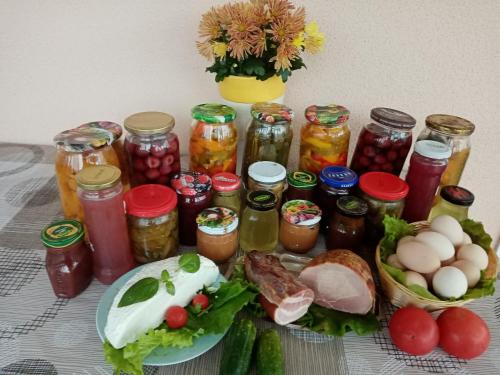 a table with jars of pickles and a plate of food at VILLA GUT in Bolesławiec