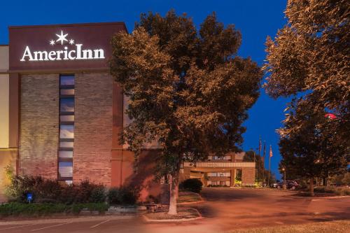 a building with an american firm sign on it at AmericInn by Wyndham Omaha in Omaha