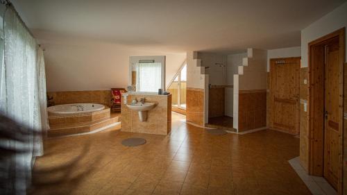 a large bathroom with a tub and a sink at Ferienhaus MountFrosch mit Sauna und Naturpool in Monschau