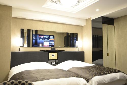 מיטה או מיטות בחדר ב-APA Hotel Saitama Higashimatsuyama Ekimae