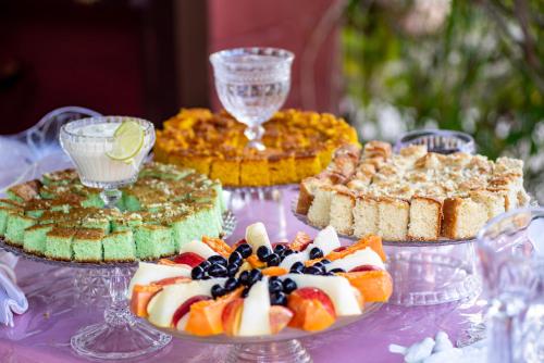 a table topped with different types of cakes and pies at Pousada Quatro Estações Paraty in Sertão do Taquari