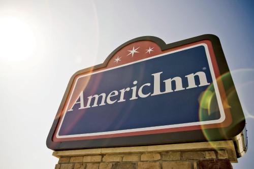 a sign for an americanim on top of a building at AmericInn by Wyndham Osage in Osage