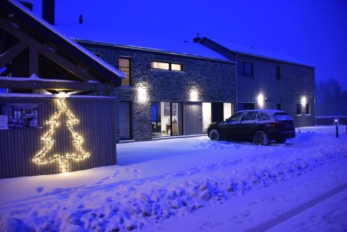 a house with a christmas tree in the snow at Rochehaut, Les Semoiselles, Villa Isabelle in Bouillon