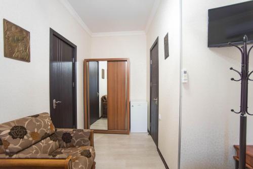 a living room with a couch and a mirror at Terrace House Near Opera in Tbilisi City
