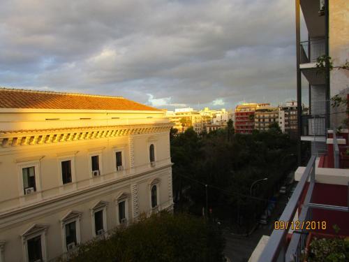 a white building with an orange roof in a city at Hotel Costa in Bari