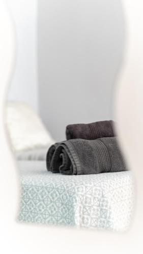 a white bed with towels on top of it at Apartamentos Castillo by Sur Suites in Fuengirola