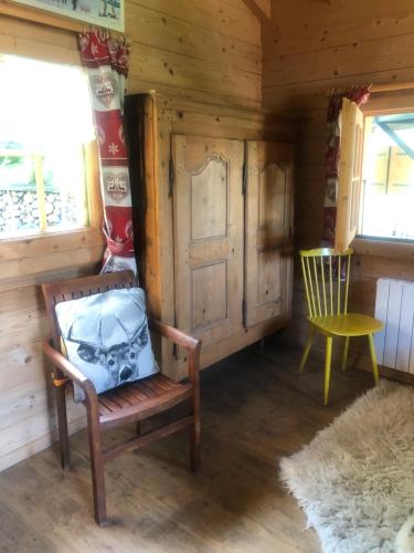 a wooden room with a bench and a chair at Chalet Dufour in Morzine