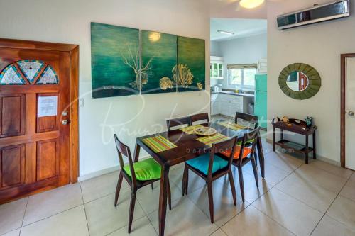 a kitchen and dining room with a table and chairs at Stunning Loft 2 Floor Unit with Balcony in Contadora