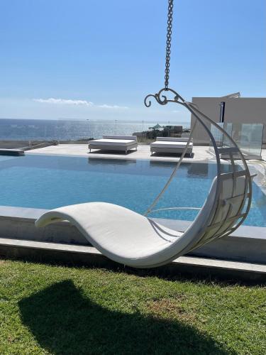 a swing hanging from the side of a swimming pool at Villa Proistakis in Achlia