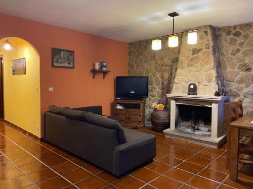 a living room with a couch and a fireplace at El Abigero in La Fregeneda