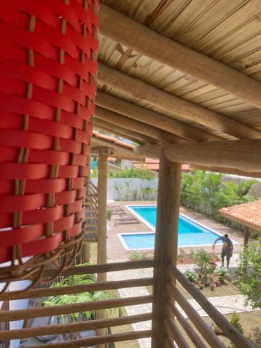 an overhead view of a wooden pergola and a swimming pool at Pousada Vila Mangaba in Arraial d'Ajuda