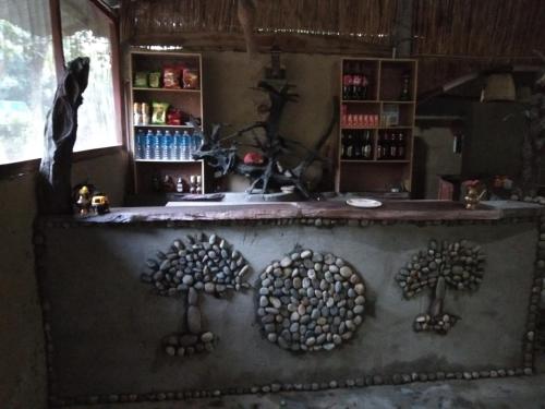 a kitchen with a counter with trees on it at Chital lodge in Chitwan