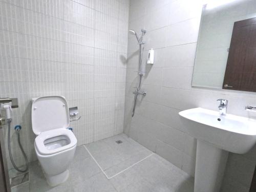 a bathroom with a toilet and a sink at Barsha Star Residence - Home Stay in Dubai