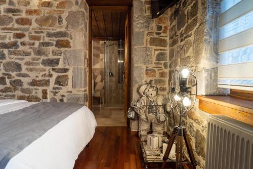 a teddy bear sitting on a table next to a bedroom at Helene Eco Luxury Villa in Tsagarada