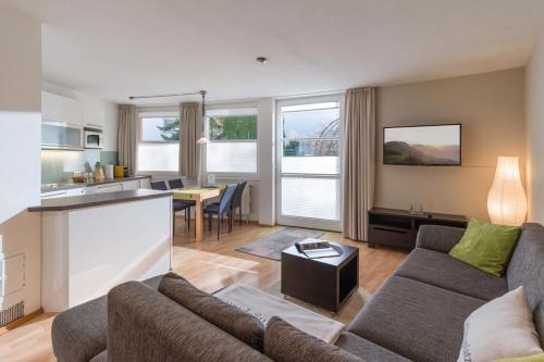 a living room with a couch and a table at Kaiserhoam in Söll