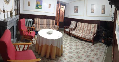 a living room with a table and chairs at Casa rural "La Bodega" in Cehegín