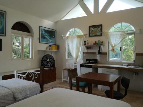 a bedroom with a bed and a desk and a table at Casa del Arquitecto in Cancún