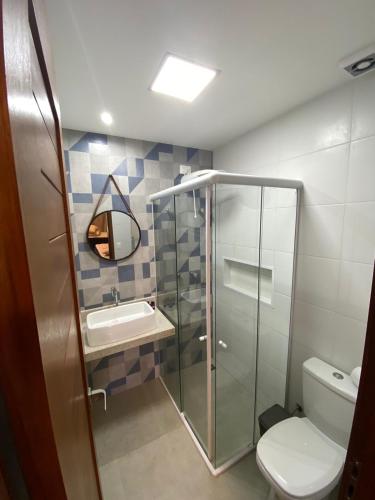 a bathroom with a shower and a toilet and a sink at Pousada Maresia in Fernando de Noronha