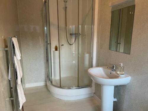 a bathroom with a shower and a sink at Shandwick House in Tain