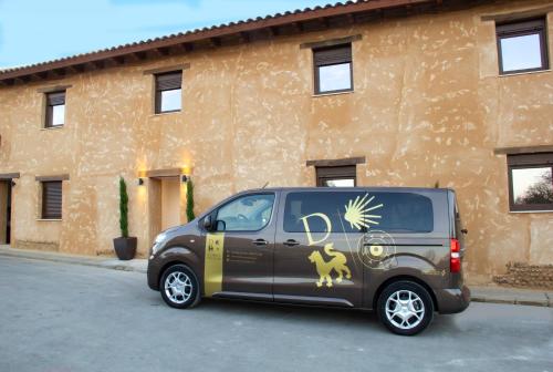 a van parked in a parking lot in front of a building at Domus Oncinae in Oncina de la Valdoncina