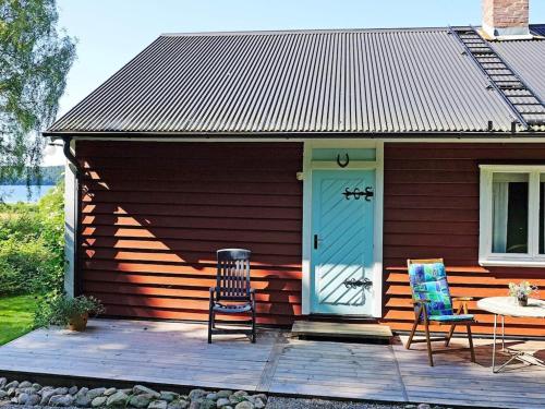 a house with two chairs and a blue door at 5 person holiday home in HEN N in Henån
