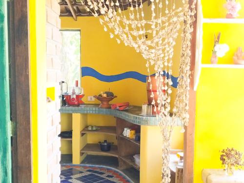 a toy kitchen with a yellow wall and a shelf at Casa da Floresta Santo André in Santo André