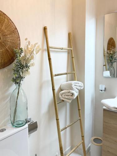 a ladder leaning against a wall with a towel at Casa del Sol - with Home Office space in Playa de San Juan