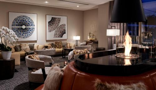 a living room with a fire pit in the middle at Hinode Hills Niseko Village in Niseko