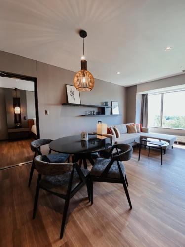 a living room with a table and a couch at Hinode Hills Niseko Village in Niseko