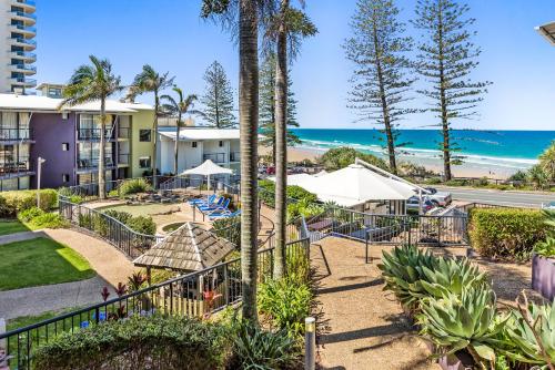 a resort with a beach and the ocean at Coolum Beachside Studio in Coolum Beach