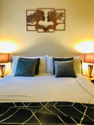 a bedroom with a large white bed with two lamps at Station View Lodge - near Balbirnie House Markinch in Markinch