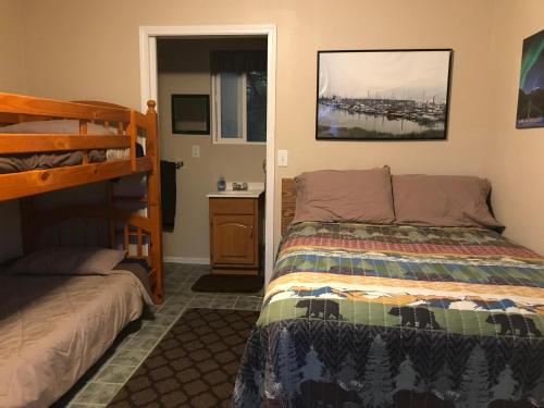 a bedroom with a bed and a bunk bed at Cabin 2 Lynn View Lodge in Haines