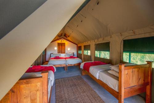 a bedroom with two beds in a tent at Namushasha River Camping2Go in Kongola