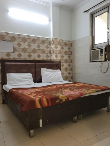 a bedroom with a large bed with at Asha Guest House in Amritsar