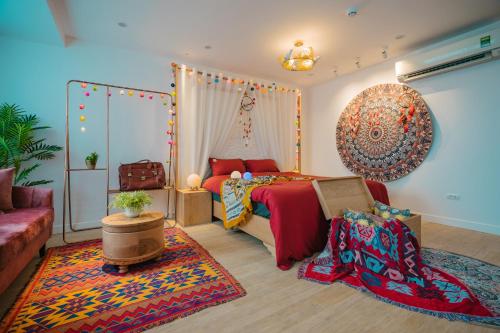 a bedroom with a bed and a couch and a rug at K6 Homestay in Hanoi