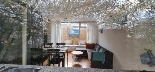 a living room with a couch and a table at Ferienhaus Abenteuer in Egmond aan Zee