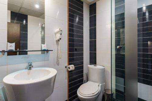 a bathroom with a toilet, sink, and shower at Hotel Ego in Plovdiv