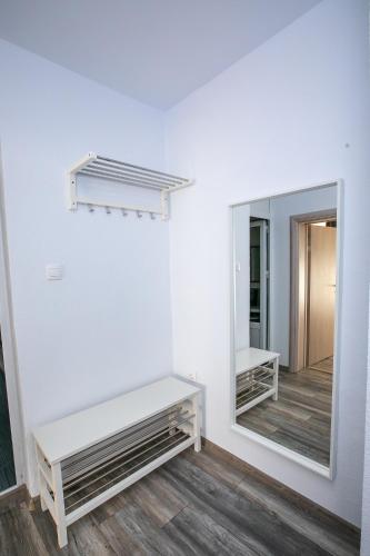 a dressing room with a mirror and a bench at Aparthouse Heaven in Sandanski