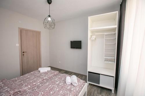 a bedroom with a bed and a walk in closet at Aparthouse Heaven in Sandanski