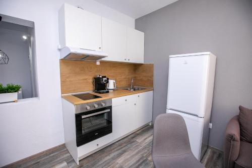 a small kitchen with a sink and a refrigerator at Aparthouse Heaven in Sandanski