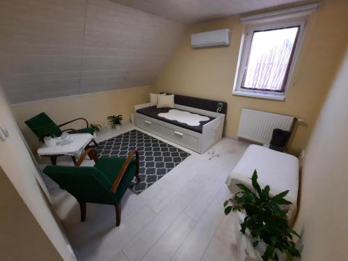 a small room with a bed and a table and chairs at Sarkcsillag Vendégház in Kiskőrös